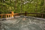 Hot tub surrounded by the woods